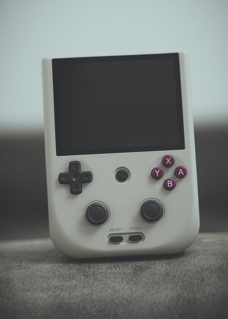 Close-up of a vintage handheld gaming console with classic design and retro buttons.