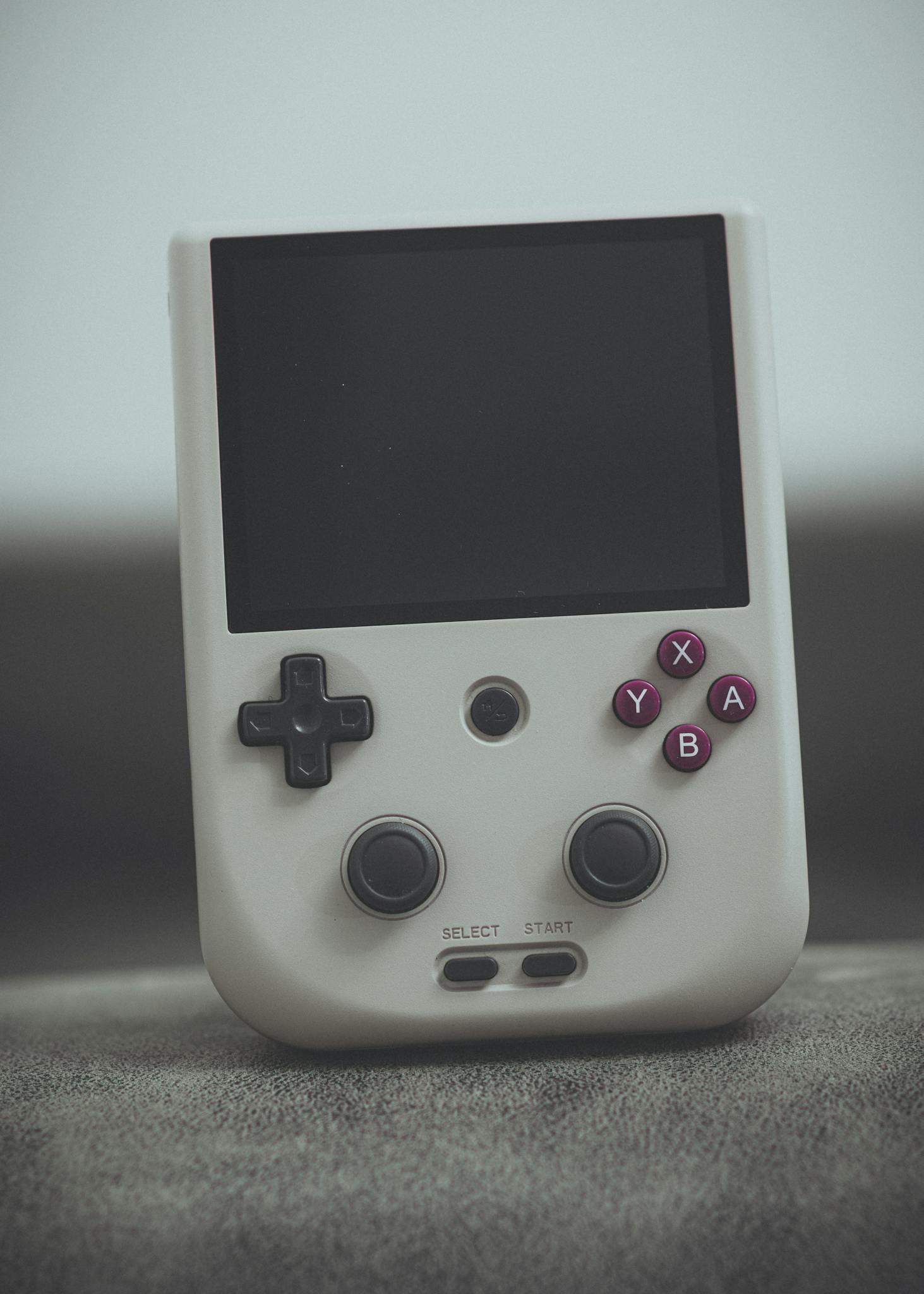 Close-up of a vintage handheld gaming console with classic design and retro buttons.