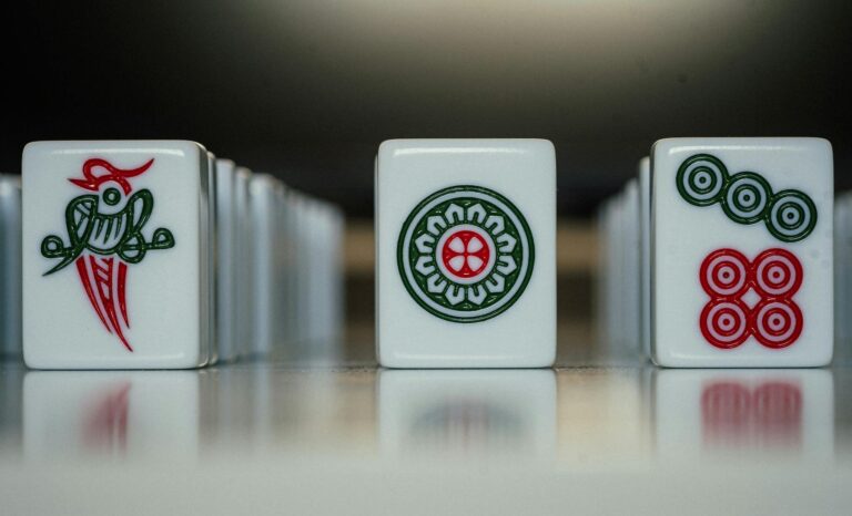 Detailed close-up of mahjong tiles showcasing intricate designs. Perfect for themes of strategy and leisure.